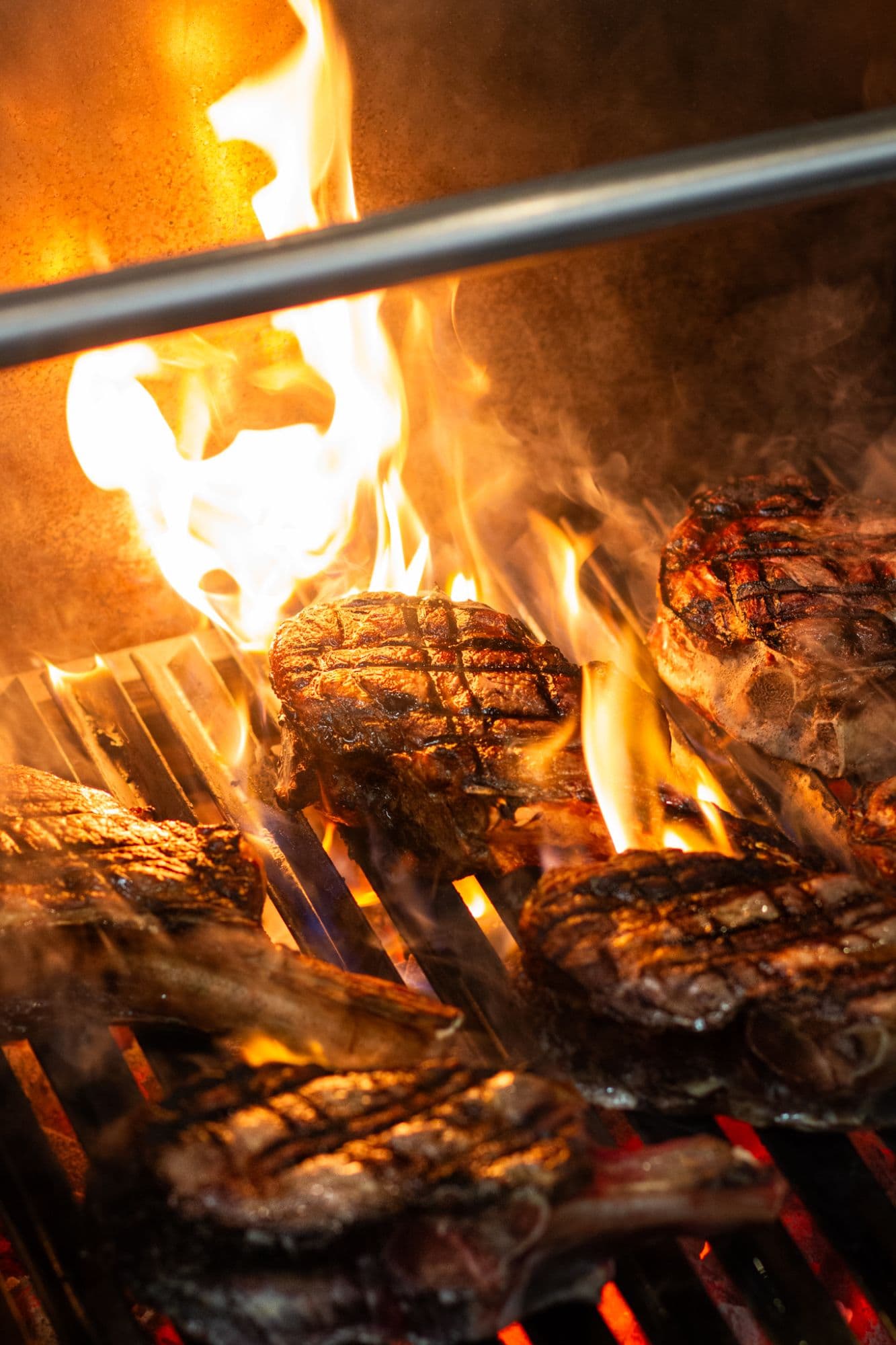 Steaks on the charcoal grill, tongs at hand
