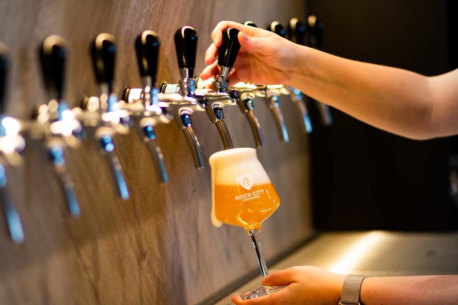 A tulip glass being poured at the Tjaps tap wall